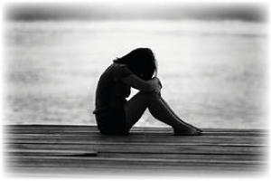 woman crouched on decking. Click here to find out the types of therapy we cover.